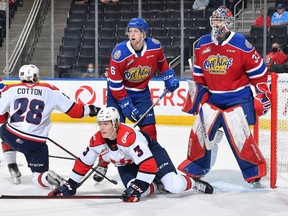 Cutline: Edmonton Oil Kings defenceman Luke Prokop, (No.6) battles for position in front of the net against Paul Chase (No. 3) and Alex Cotton (No. 28) of the Lethbridge Hurricanes, while goaltender Sebastian Cossa looks on, in a WHL game at Rogers Place in Edmonton on Oct. 15, 2021.