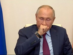 Russian President Vladimir Putin is seen coughing during a televised government meeting in this screen capture.