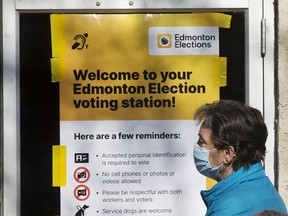 Edmontonians wait for the the advance polling station at the Hazeldean Community League, 9630 66 Avenue, to open in Edmonton, Monday Oct. 4, 2021. As well as the municipal election, residents across Alberta will also be voting on two referendum questions regarding equalization and year-round Daylight Saving Time, and a Senate election.