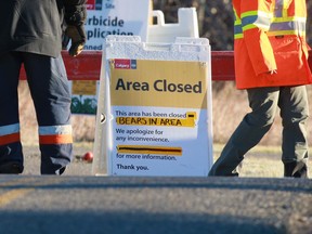 City of Calgary workers have closed a pathway in South Glenmore Park after a bear and cub were spotted in the Cedarbrae and Oakridge communities in Calgary on Tuesday, Oct. 12, 2021.