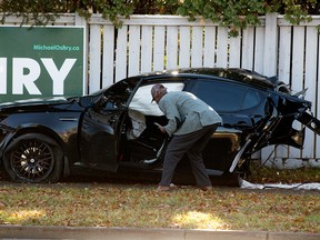 A man surveys the scene of a crash along 153 Avenue east of 66 Street in Edmonton on Oct. 24, 2021. One person was transported to hospital in stable condition.