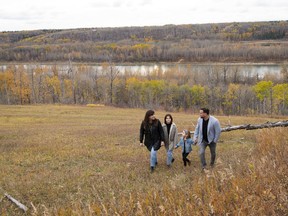 Janene and Anthony Pedatella with their daughters Vienna, 12, and Iyla, 6, go for a walk in behind their soon-to-be built home.