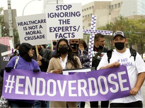 Participants in International Overdose Awareness Day march through Edmonton on Aug. 31, 2021.