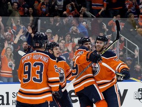 The Edmonton Oilers' Leon Draisaitl (A) (29) and Connor McDavid (C) (97) celebrate Draisaitl's first period goal against the Anaheim Ducks during NHL action at Rogers Place, in Edmonton Tuesday Oct. 19, 2021.