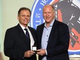 Member of the selection committee Mike Gartner (L) presents a Hall of Fame ring to Kevin Lowe at the Hockey Hall Of Fame on November 12, 2021 in Toronto.
