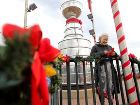 Ora Barker puts up Christmas decorations around the Stanley Cup replica outside United Sport & Cycle, 7620 Gateway Blvd., in Edmonton Wednesday Nov. 3, 2021. Photo by David Bloom