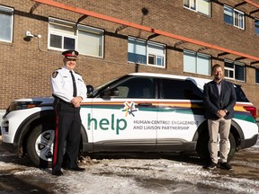 Edmonton Police Service Chief Dale McFee and Mike Ellis, associate minister of mental health and addictions, are seen with a HELP SUV during the Alberta government's announcement of an additional $600,000 in funding for the Edmonton Police Service's Human-centred Engagement and Liaison Partnership (HELP) teams in Edmonton, on Friday, Nov. 19, 2021.