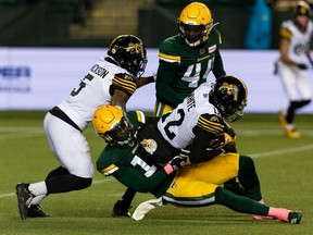 Edmonton Elks coverage linebacker Derrick Moncrief (10) tackles Hamilton Tiger-Cats ball carrier Tim White (12) at Commonwealth Stadium in Edmonton on Oct. 29, 2021.