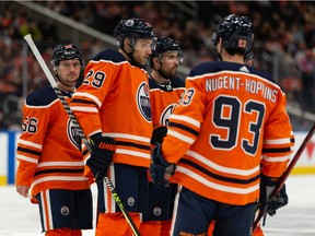 Edmonton Oilers' Leon Draisaitl (29), Kailer Yamamoto (56), Ryan Nugent-Hopkins (93) chat as they face the Nashville Predators during first period NHL action at Rogers Place in Edmonton, on Wednesday, Nov. 3, 2021. Photo by Ian Kucerak