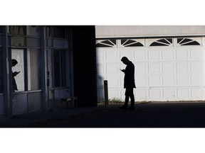 A customer waits outside a store near 124 Street and 107 avenue on Thursday, Nov. 4, 2021 in Edmonton . Greg Southam-Postmedia