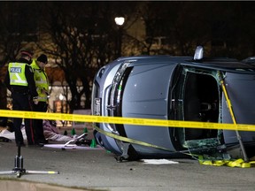 Edmonton Police Service officers investigate a crash involving a motorcycle and a car on 97 Street near 137 Avenue in Edmonton, on Thursday, Nov. 4, 2021. A 44-year-old motorcyclist died in the collision.