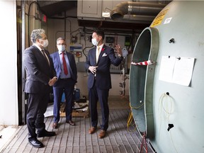 Daniel Vandal, Minister of Northern Affairs, Minister responsible for Prairies Economic Development Canada and Minister responsible for the Canadian Northern Economic Development Agency (left) inspects a special environment chamber at C-FER Technologies with Francisco Alhanati, Managing Director, C-FER Technologies (centre) and Kirk Hamilton Senior engineering advisor, C-FER Technologies after  announcing funding of $1.35 million through PrairiesCan to help modernize C-FER technologies to test their products and processes to demonstrate the value of Canadian-made technologies for the global hydrogen industry. Tuesday, Nov. 9, 2021 in Edmonton.