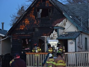 Firefighters on the scene of a house fire at 11310 93 St. in Edmonton on Thursday, Nov. 11, 2021.