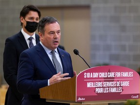 Prime Minister Justin Trudeau (left) listens while Alberta Premier Jason Kenney answers a questions about climate change policy during a joint federal-provincial announcement of $10-a-day daycare at Boyle Street Plaza in Edmonton, on Monday, Nov. 15, 2021.