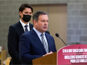 Prime Minister Justin Trudeau (left) listens while Alberta Premier Jason Kenney answers a questions about climate change policy during a joint federal-provincial announcement of $10-a-day daycare at Boyle Street Plaza in Edmonton, on Monday, Nov. 15, 2021. Photo by Ian Kucerak