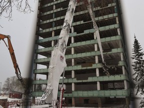 Infrastructure Minister Prasad Panda held up a green flag to signal the dismantling of the Annex Building to begin on the Legislature grounds in Edmonton, November 16, 2021.