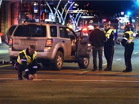 The police collision investigators on the scene of a female pedestrian hit by vehicle on Jasper Avenue and 102 Street in Edmonton, on Tuesday, Nov. 30, 2021.