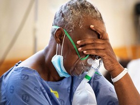 A patient with the COVID-19 breaths in oxygen at Khayelitsha Hospital, about 35km from the centre of Cape Town, on December 29, 2020.