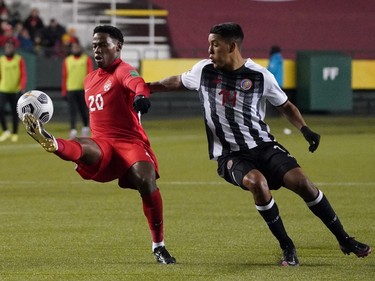 Team Canada's Jonathan David (20) and Team Costa Rica's Orlando Calderon (14) battle for the ball during a FIFA 2022 World Cup qualifier soccer match held at Commonwealth Stadium in Edmonton, Canada on Friday November 12, 2021. David's goal clinched the game win for Team Canada with the final score of 1-0. (PHOTO BY LARRY WONG/POSTMEDIA)