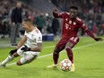 Bayern's Alphonso Davies, right, stops Benfica's Gilberto during the Champions League group E soccer match between Bayern Munich and Benfica Lisbon in Munich, Germany, Tuesday, Nov. 2, 2021.