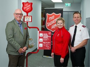 Patrick LaForge, former Edmonton Oilers president leading this year's Salvation Army Red Kettle Campaign, with two Army assistants, Maj. Elaine Locke and Maj. Jamie Locke.