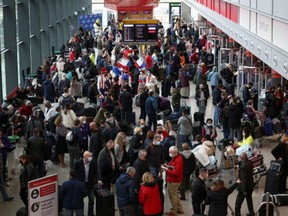 Performers engage with travellers as they queue to check into Virgin Atlantic and Delta Air Lines flights at Heathrow Airport Terminal 3, following the lifting of restrictions on the entry of non-U.S. citizens to the United States imposed to curb the spread of the coronavirus disease (COVID-19), in London, Britain, November 8, 2021.