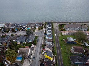 Homes on Boundary Bay in Delta, B.C., left, and Point Roberts, Wash., right, are separated by the Canada-U.S. border which is just north of Roosevelt Way, centre, in Point Roberts, as seen in an aerial view on Wednesday, October 13, 2021.