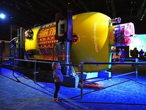 Two-year-old William Barton marvels at the Deepsea Challenger sub on display at the Telus World of Science in Edmonton on Friday, Nov. 5, 2021, where the James Cameron — Challenging The Deep Exhibition makes its Canadian premiere.