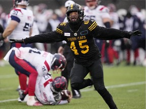 Hamilton Tiger-Cats linebacker Jovan Santos-Knox (45) celebrates after sacking Montreal Alouettes quarterback Trevor Harris (17) during second half CFL division semi-final football action in Hamilton, Ont., on Sunday, November 28, 2021.