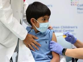Jaishan Baweja, 8, reacts as he receives the Pfizer-BioNTech COVID-19 vaccine at Cohen Children's Medical Center as vaccines were approved for children aged 5-11, amid the coronavirus disease pandemic, in New Hyde Park, New York, U.S., November 4, 2021.