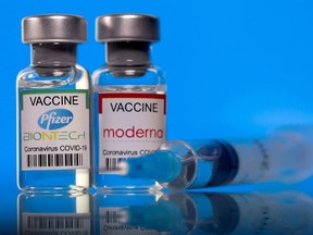 Vials with Pfizer-BioNTech and Moderna coronavirus disease (COVID-19) vaccine labels are seen in this illustration picture taken March 19, 2021.