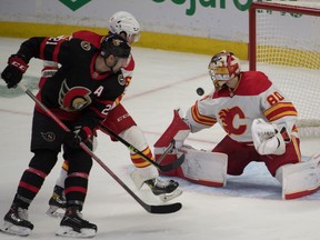 Calgary Flames goalie Dan Vladar (80) makes a save in front of Ottawa Senators left wing Nick Paul (21) in the third period at the Canadian Tire Centre.