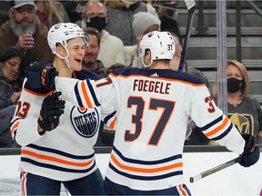 Edmonton Oilers right wing Jesse Puljujarvi (13) celebrates with Edmonton Oilers left wing Warren Foegele (37) after scoring a second period goal against the Vegas Golden Knights at T-Mobile Arena.