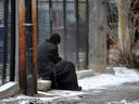 A homeless man sits in a back alley in downtown Edmonton.  File photo.