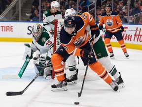 Zach Hyman #18 of the Edmonton Oilers looks for an opportunity against goaltender Cam Talbot #33 of the Minnesota Wild during the second period at Rogers Place on December 7, 2021 in Edmonton.