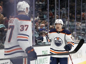 Warren Foegele #37 celebrates his goal with Kailer Yamamoto #56 of the Edmonton Oilers during the first period against the Seattle Kraken at Climate Pledge Arena on December 18, 2021 in Seattle, Wash.