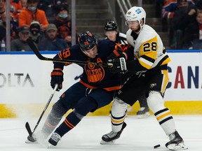 The Edmonton Oilers’ Leon Draisaitl (29) battles the Pittsburgh Penguins’ Marcus Pettersson (28) at Rogers Place in Edmonton on Wednesday, Dec. 1, 2021.