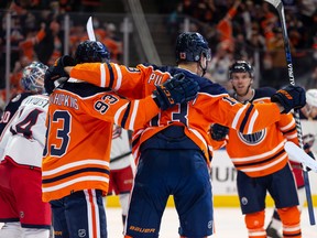 Edmonton Oilers forward Jesse Puljujarvi (13) celebrates a goal against Columbus Blue Jackets goaltender Elvis Merzlikins (90) with teammates at Rogers Place in Edmonton on Thursday, Dec. 16, 2021.