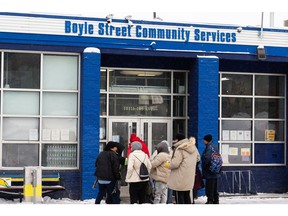 People line up to enter Boyle Street Community Services in Edmonton, on Saturday, Dec. 25, 2021. The organization is hosting a Christmas dinner with the support of Arcadia Brewing and Edmonton's Food Bank. Photo by Ian Kucerak