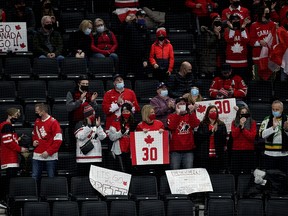 Team Canada fans celebrate a third period goal against eam Austria during IIHF World Junior Hockey Championship action in Edmonton on Tuesday, Dec. 28, 2021. Photo by David Bloom