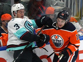 Edmonton Oilers winger Zach Hyman (right) collides with Seattle Kraken defenceman Will Borgen (left) in Edmonton on Sept. 28, 2021.