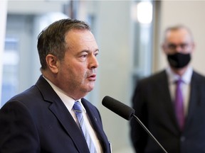 Premier  Jason Kenney talks about the provincial government providing  up to $81.2 million to fund four proposals for vaccine development and manufacturing while Bill Flanagan, president and vice-chancellor, University of Alberta listens on Wednesday, Dec. 1, 2021  in Edmonton.