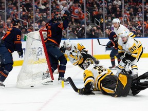 Edmonton Oilers' Zach Hyman (18) scores on Pittsburgh Penguins goaltender Tristan Jarry (35) during third period NHL action at Rogers Place in Edmonton, on Wednesday, Dec. 1, 2021. The goal, which was celebrated as a hat-trick, was ruled off.