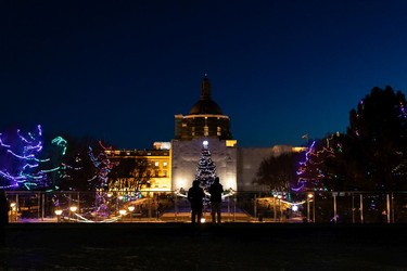 Visitors take in holiday lights during the annual Legislature Light-Up hosted by Premier Jason Kenney in Edmonton, on Thursday, Dec. 2, 2021. The event kicks off Celebrate the Season at the Alberta Legislature.