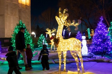 A family takes in holiday lights during the annual Legislature Light-Up hosted by Premier Jason Kenney in Edmonton, on Thursday, Dec. 2, 2021. The event kicks off Celebrate the Season at the Alberta Legislature.
