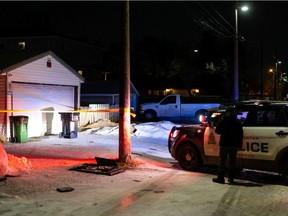 Crime scene tape surrounds an area behind a house where Edmonton Police Service officers are investigating a suspicious death at a home near 67 Street and 127 Avenue in Edmonton on Friday, Dec. 3, 2021.
