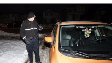 EPS Const. Brett Earley inspects an unattended car that was left running on Tuesday, Dec. 7, 2021 in Edmonton.    As temperatures drop and winter settles in across northern Alberta, incidents involving theft of vehicles left idling are on the rise across Edmonton.
Once again this year, the EPS Operation Cold Start program is attempting to change citizens' habits with respect to leaving their idling vehicles unattended, unlocked and often with keys inside.