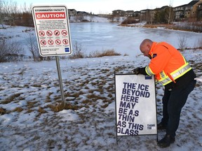 EPCOR Darren Gwozdz, senior health and safety manager setting up a campaign sign ,as they roll out their Community League Safe Rink grant program which is part of their Annual Winter Stormwater Safety campaign. This all will help to keep children and families safe and active during the winter, and away from the risks and hidden dangers of stormwater facilities in Edmonton, December 9, 2021. Ed Kaiser/Postmedia