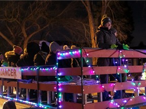 Sleigh riders look over Christmas displays as they ride along Candy Cane Lane in Edmonton, on Friday, Dec. 10, 2021. The lane, located on 148 Street between 92 and 100 Ave., runs Dec. 10 to Jan. 1 2022. Two "Walk the Lane" pedestrian nights are set for Dec. 12 and Dec. 19. Photo by Ian Kucerak