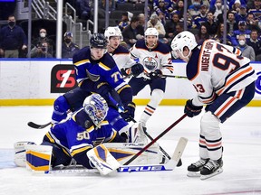 St. Louis Blues goaltender Jordan Binnington (50) and defenceman Niko Mikkola (77) take on Edmonton Oilers forward Ryan Nugent-Hopkins (93) at Enterprise Center on Wednesday, Dec. 29, 2021.